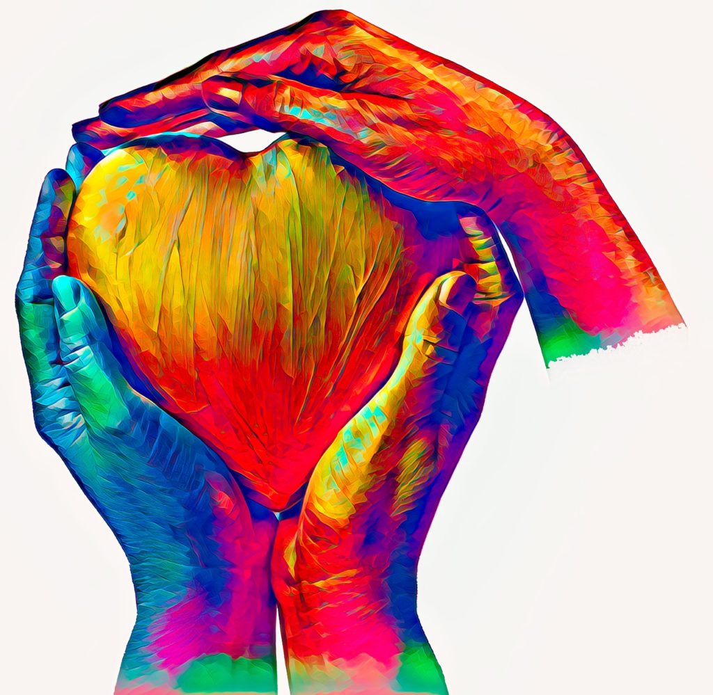 Colorful hands holding a heart