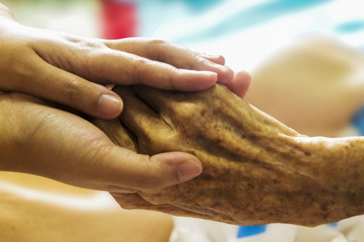 old and young hands touching